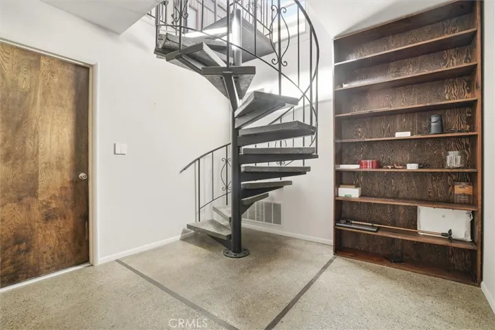 Spiral Staircase to downstairs. Door to garage.