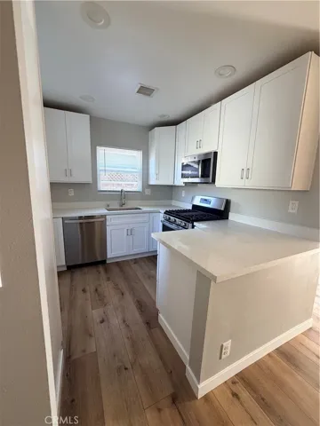 Beautiful updated kitchen with all appliances, quartz counter tops, white shaker cabinets, refrigerator, washer & dryer