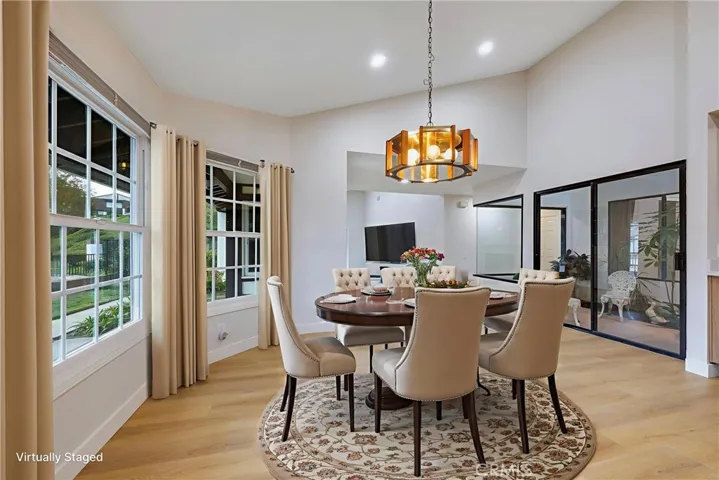 View from kitchen toward dining room with view of atrium beyond the glass doors on the right side