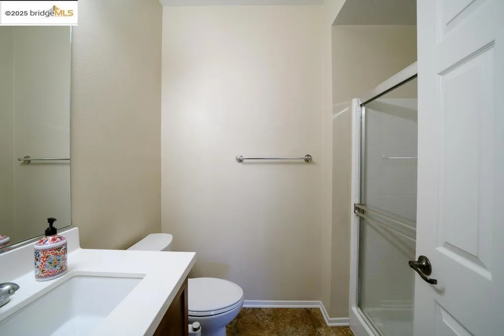 Bathroom featuring vanity and a stall shower