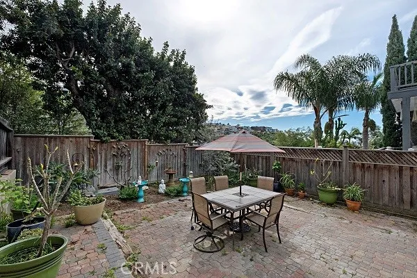 Large private outdoor rear patio surrounded with mature trees