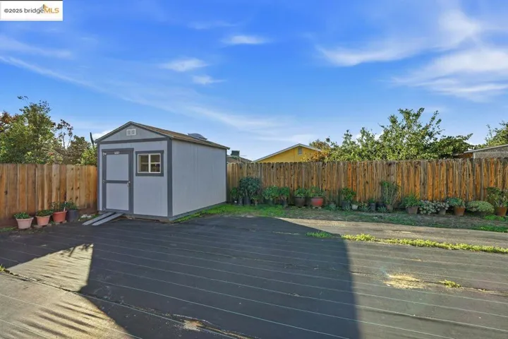 Wooden deck featuring a storage unit and a fenced​​‌​​​​‌​​‌‌​​‌​​​‌‌​​​‌​​‌‌​​‌‌​​‌‌​​​​ backyard