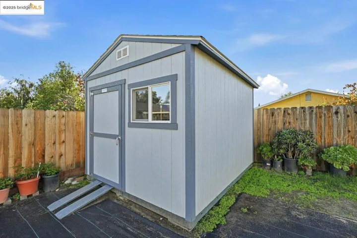 View of shed with a fenced backyard
