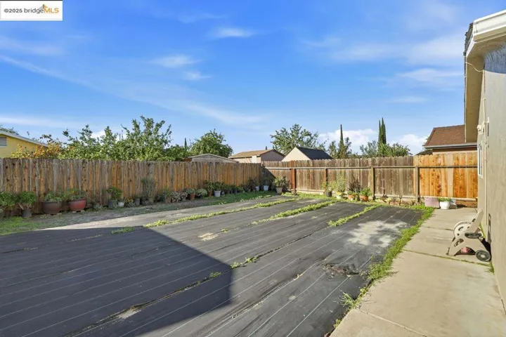 Wooden deck with a fenced backyard