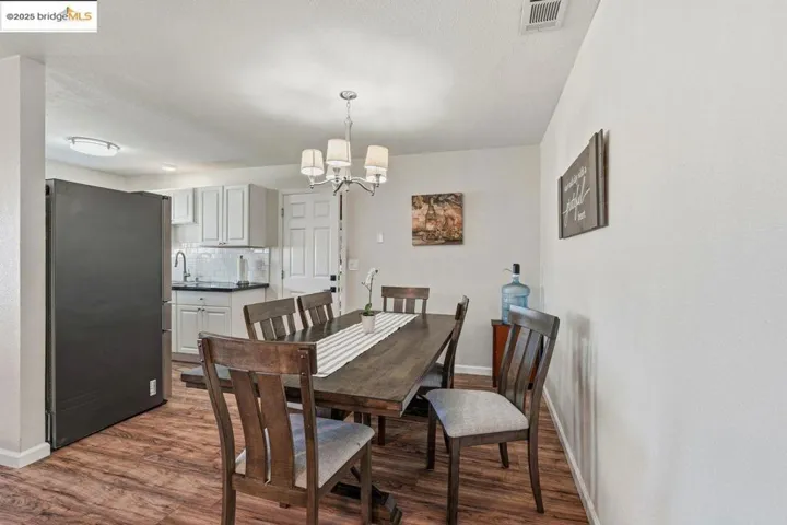 Dining area featuring a chandelier and dark wood-style floors