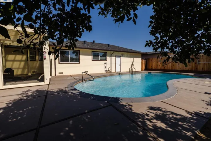 Enjoy a spacious 10-ft deep pool with a wide concrete deck, open yard, and plenty of sun—perfect for swimming, relaxing, or hosting. A great outdoor space ready for fun and comfort.