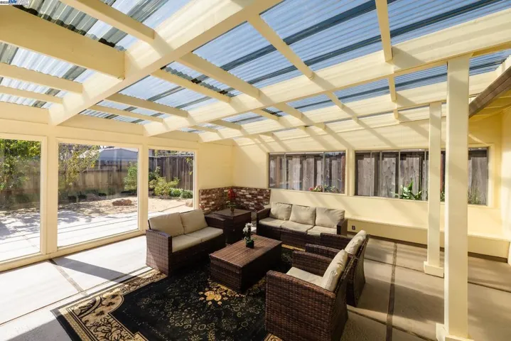 Spacious enclosed sunroom fully furnished & included with the home. Surrounded by large windows for natural light, offering direct views & access to the pool area. Perfect for indoor–outdoor living, relaxing & entertaining.