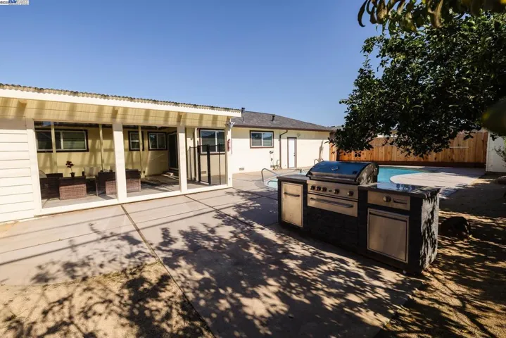 Enjoy a true California backyard with a refreshing pool, built-in BBQ island & seamless access to the enclosed sunroom. Ideal for relaxing, hosting or family gatherings, surrounded by fruit trees & generous patio space.