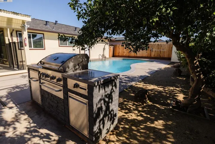 Enjoy a true California backyard with a refreshing pool, built-in BBQ island & seamless access to the enclosed sunroom. Ideal for relaxing, hosting or family gatherings, surrounded by fruit trees & generous patio space.