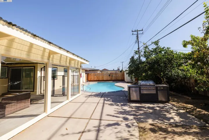 Enjoy a true California backyard with a refreshing pool, built-in BBQ island & seamless access to the enclosed sunroom. Ideal for relaxing, hosting or family gatherings, surrounded by fruit trees & generous patio space.