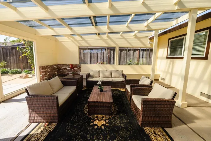 Spacious enclosed sunroom fully furnished & included with the home. Surrounded by large windows for natural light, offering direct views & access to the pool area. Perfect for indoor–outdoor living, relaxing & entertaining.