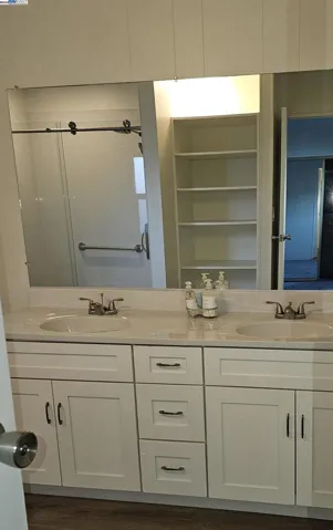 Dual sink and vanity with full mirror.