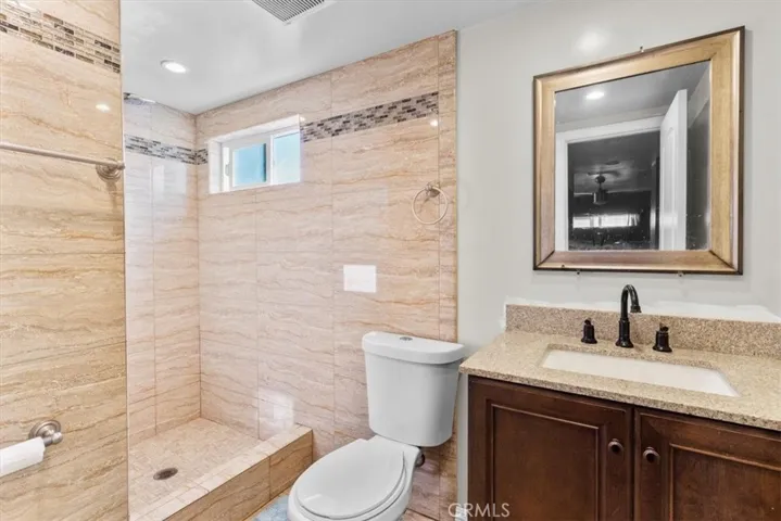 Alternate view of second bathroom showcasing shower and fixtures