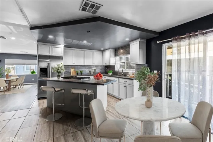 Open-concept living and dining space ideal for entertaining. Virtually staged kitchen table