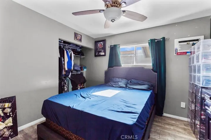 Second bedroom featuring ceiling fan and bright window views