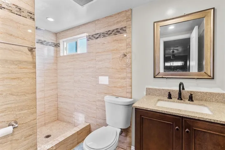 Alternate view of second bathroom showcasing shower and fixtures