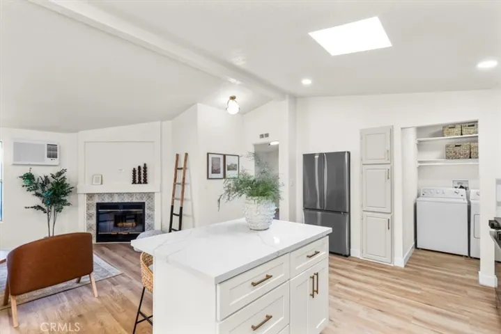 Open-concept living and dining area with wood flooring and contemporary lighting