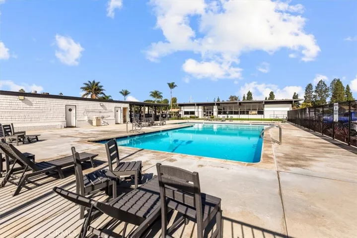 Resort-style community swimming pool with seating and relaxation space