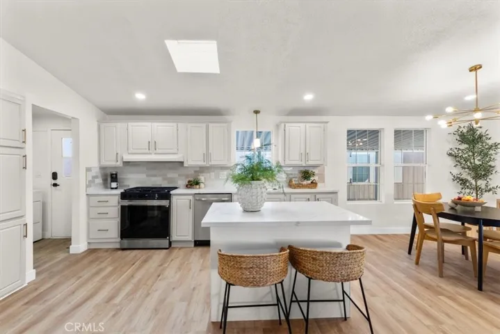 Chef’s kitchen with white cabinetry, modern fixtures, and functional layout