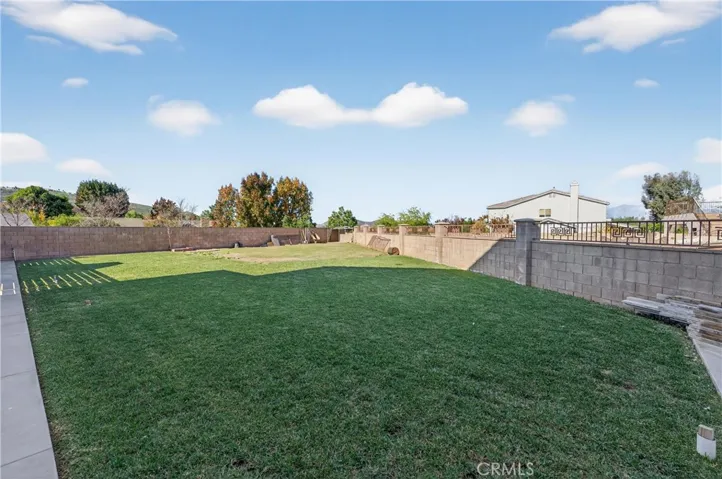 Wow, this backyard is separated by the elegant horizontal slatted fence. It has a separate entrance from the front and the seller states they have a "yes" from the county to put in a driveway or gate from Lyon.  Buyer to also investigate.