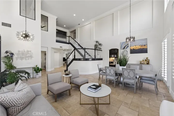 High Vaulted ceilings. Note powder room, kitchen and elegant stairway