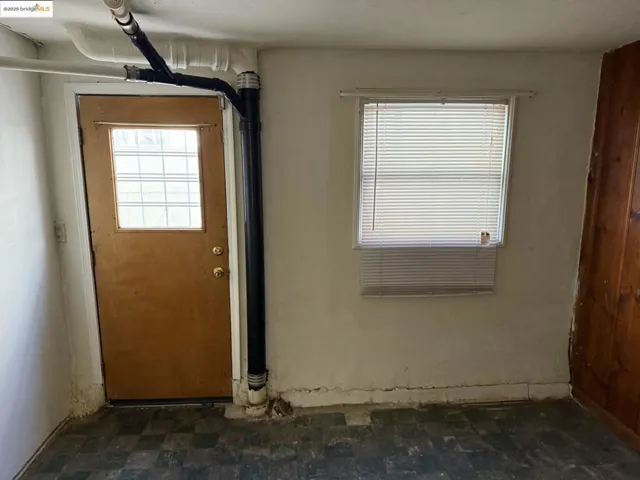 Doorway to outside with plenty of natural light and tile patterned floors
