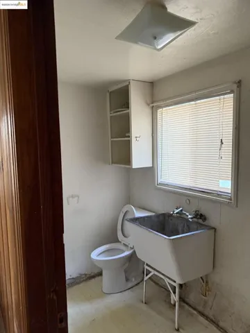 Half bath with light floors and toilet