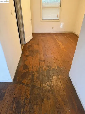 Hallway with dark wood finished floors and baseboards