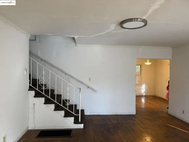 Staircase featuring hardwood / wood-style floors and baseboards