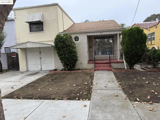 View of front facade with stucco siding, a shingled roof, a garage, and concrete driveway