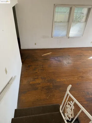 Empty room featuring dark wood-type flooring
