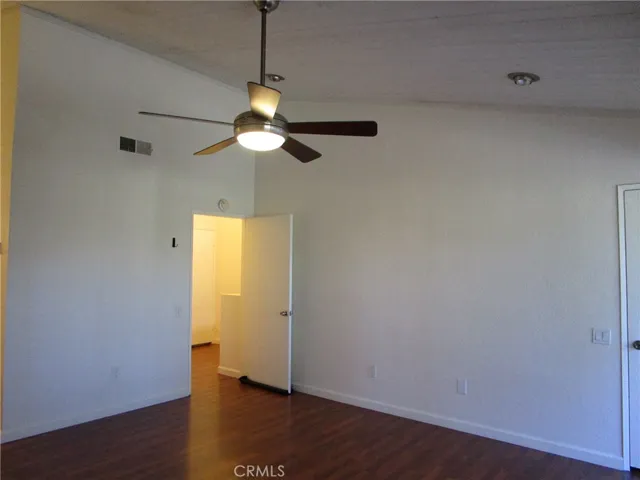 Primary bedroom with high ceiling and fan