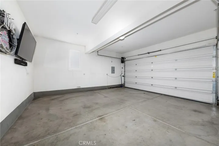 The garage features high ceilings that can accommodate a raised truck and enough space to fit two large vehicles.
