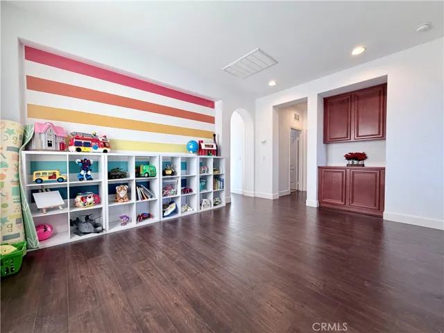 Top of the stairs, there's a large, multipurpose loft area with built in storage