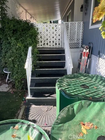Newer carpeted front porch entry and stairs. Preserved rain Water nurtures the abundant, fruit bearing trees.