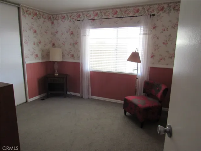 secondary bedroom with built in closet shelving