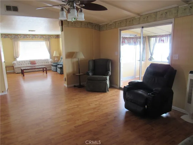 family room with ceiling fan and light
