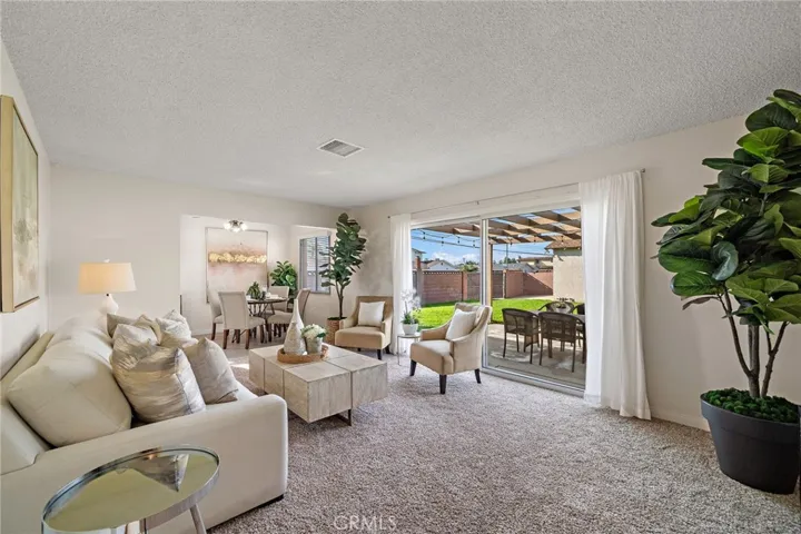 living room with sliding glass doors that open to a gigantic park-like backyard