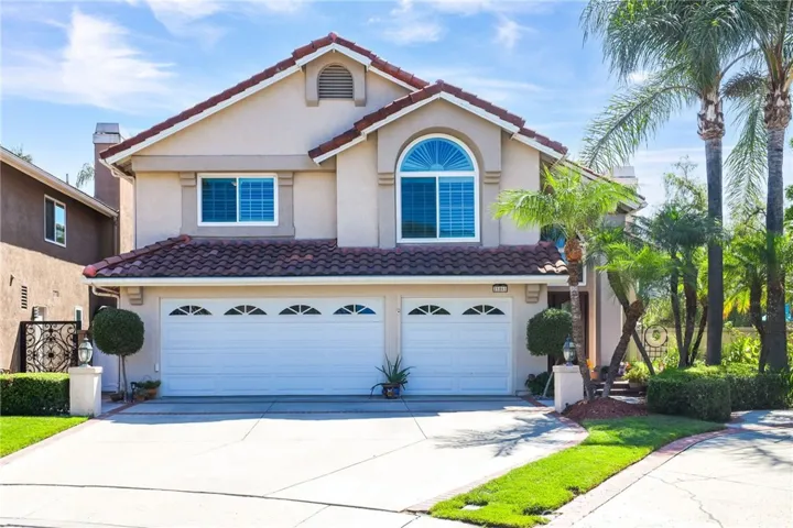 Beautiful two-story home with striking curb appeal, a three-car garage, and manicured landscaping.