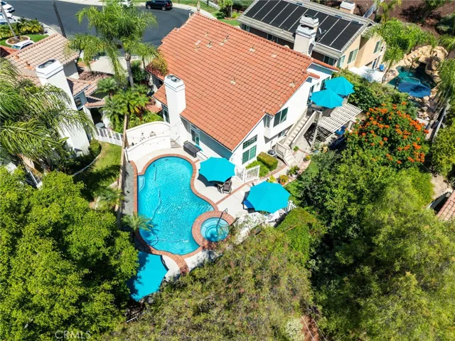 Overhead view of the backyard oasis featuring a sparkling pool and outdoor living spaces.