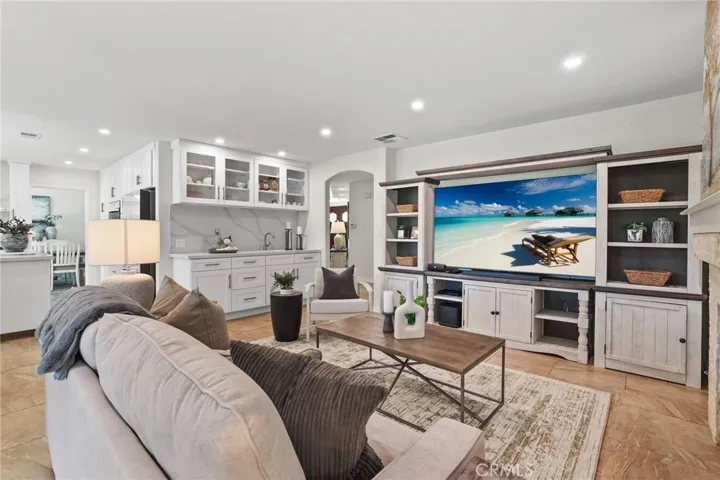 Comfortable living space featuring a fireplace and built-in shelving for added charm.