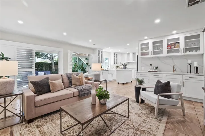 Inviting great room with recessed lighting and neutral tones for a modern, airy feel.