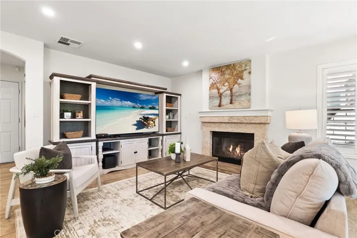 Spacious family room with abundant natural light and a cozy fireplace.