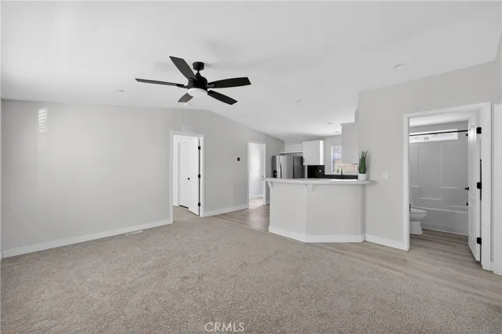 As you enter the home and glance left, you have (from the right); the full bathroom, the kitchen, the door in the kitchen leads to the laundry room (that has a door to your side yard), than you have the door to the primary suite which includes a walk-in closet and a bathroom ensuite.