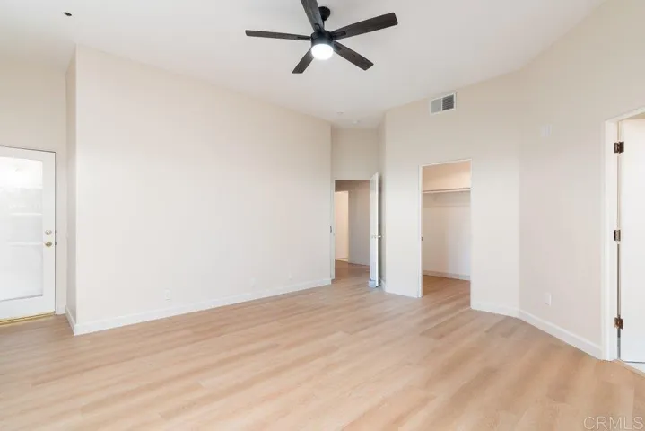 Door to left opens onto a covered viewing balcony. Doors also into hallway, walk-in closet, & bath