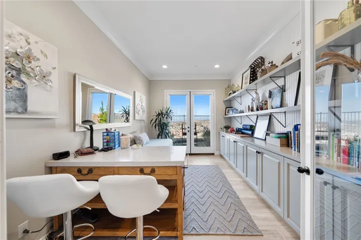 Dedicated office with designer builtins and French doors leading to the garden area.