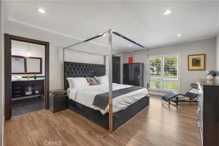 Luxury primary suite with generous windows and walk-in closet