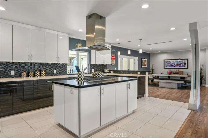 Center island topped with a designer range hood