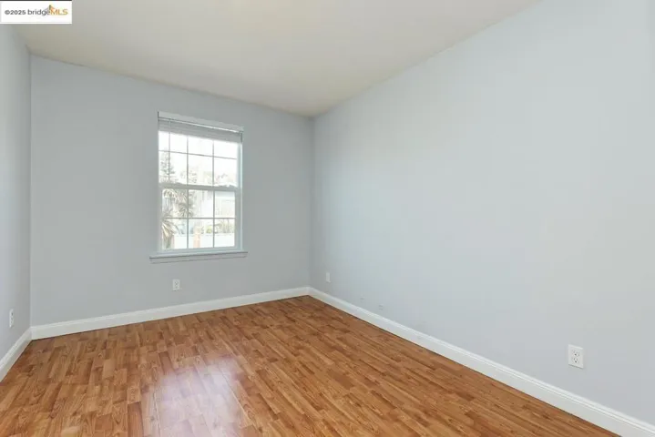 Spare room with wood finished floors and baseboards
