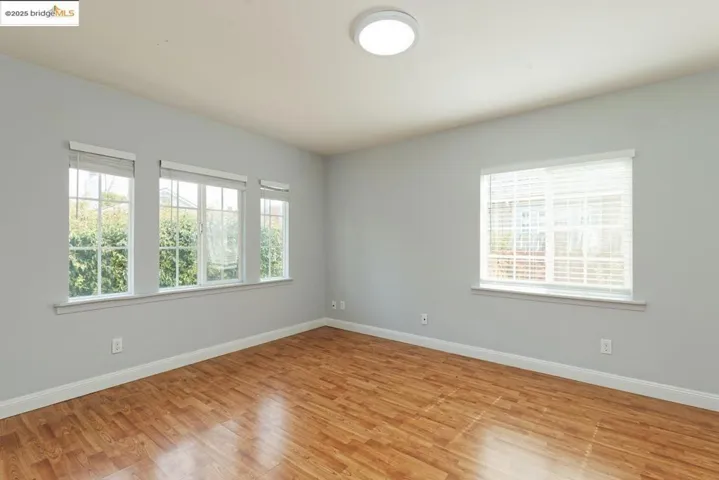 Empty room featuring healthy amount of natural light and light wood-type flooring